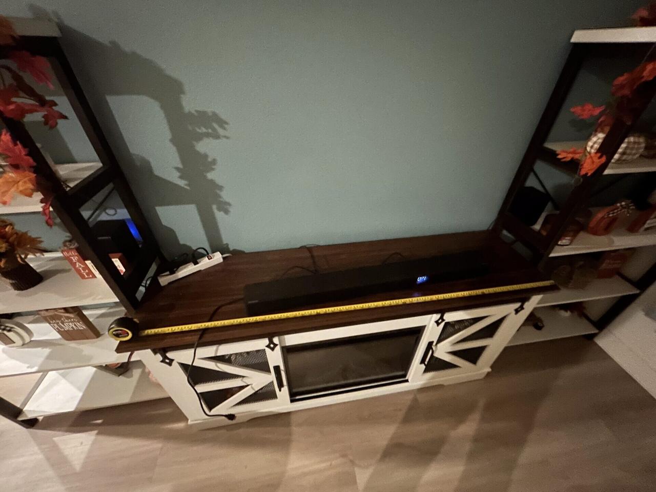 TV mounting or home theater setup detail with display placement, mount work, cabling or finished installation context