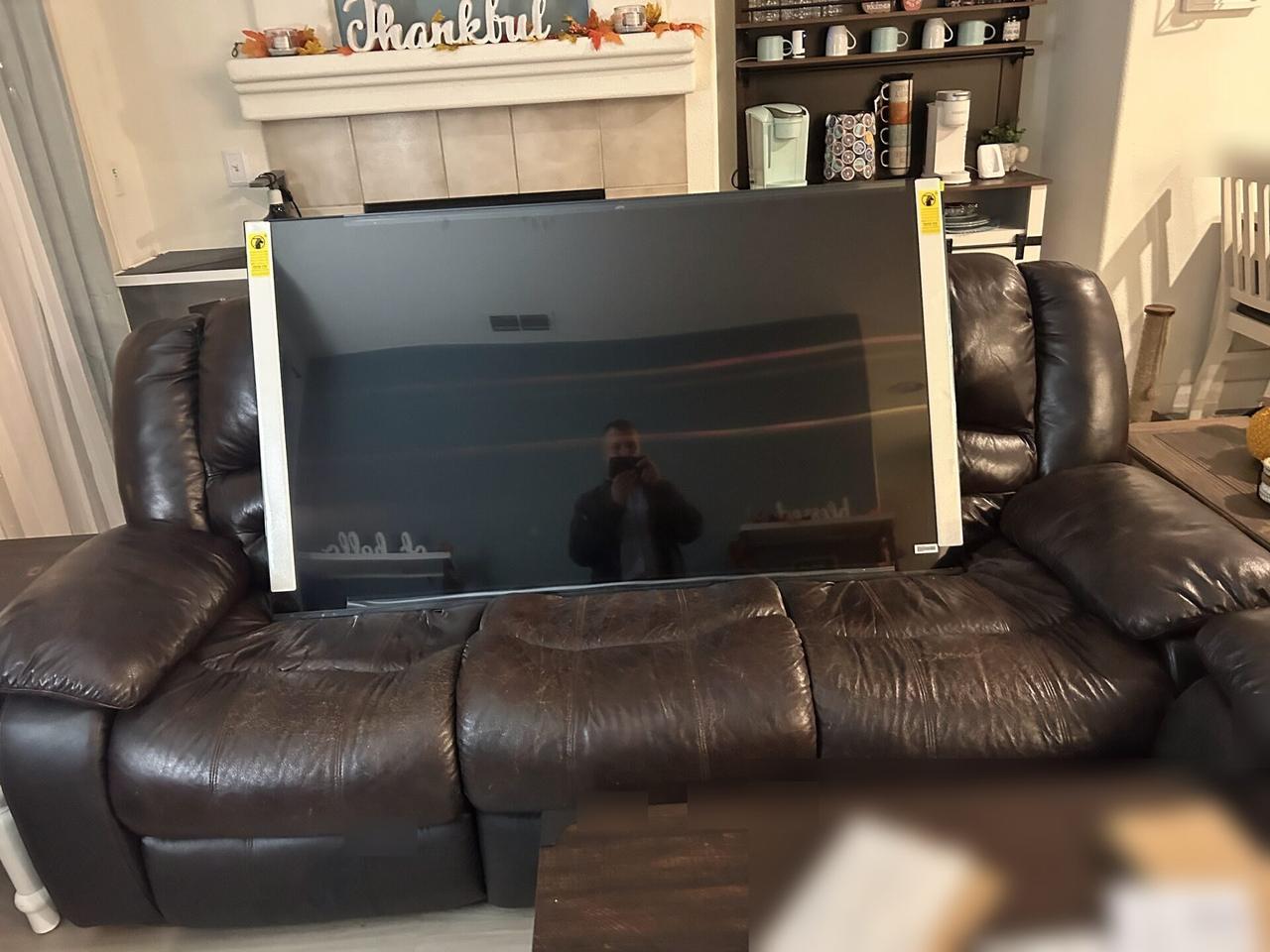 TV mounting or home theater setup detail with display placement, mount work, cabling or finished installation context