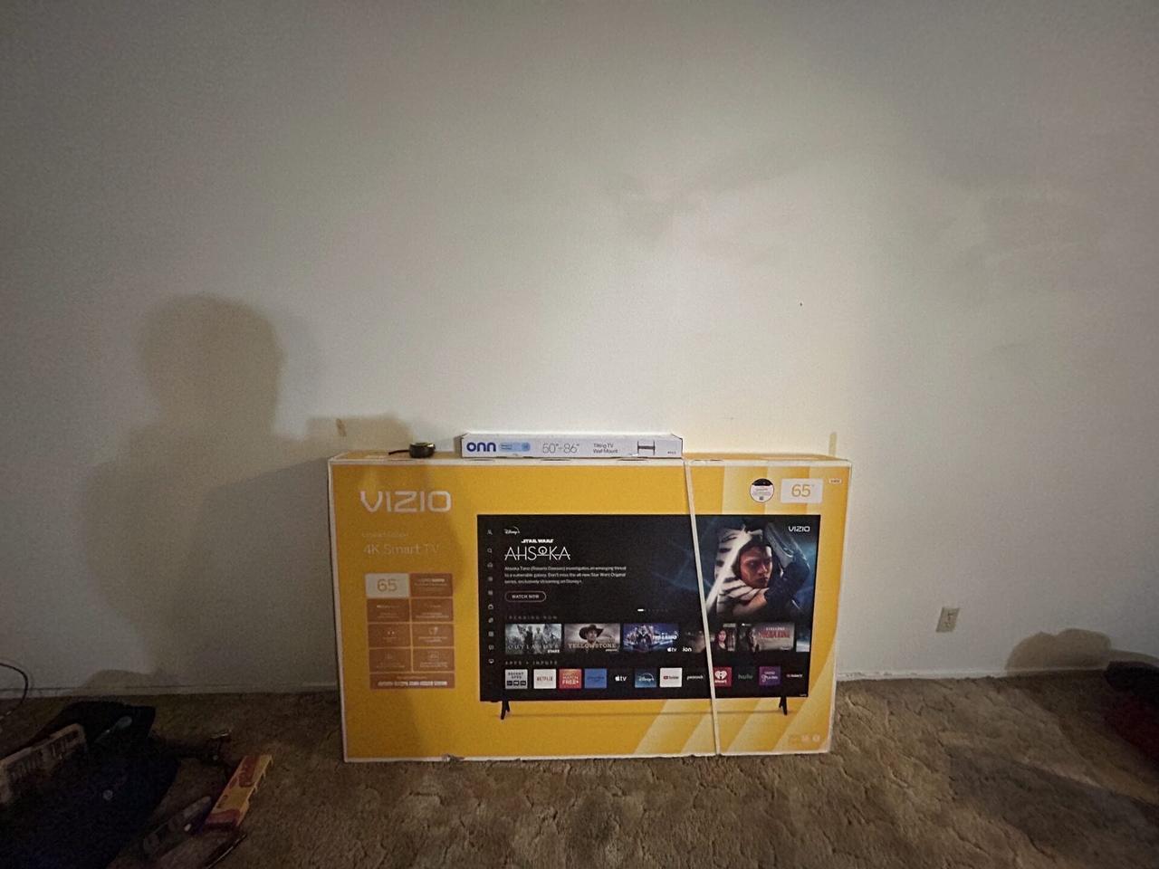 TV mounting or home theater setup detail with display placement, mount work, cabling or finished installation context