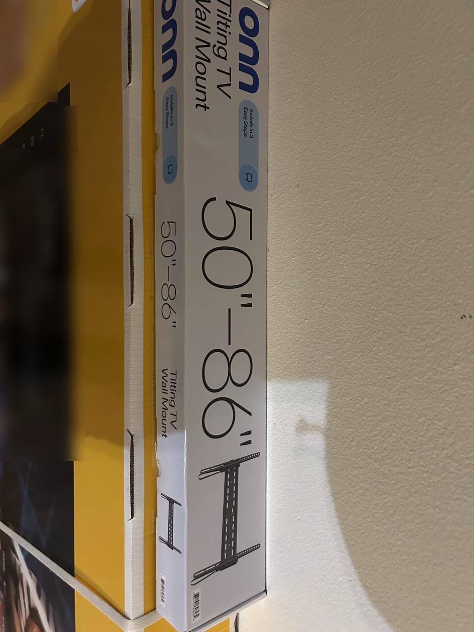 TV mounting or home theater setup detail with display placement, mount work, cabling or finished installation context