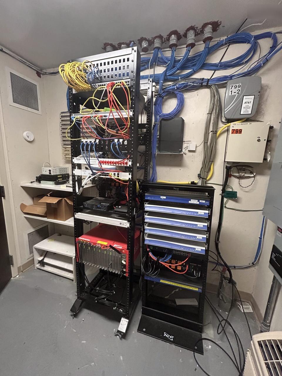 Equipment cabinet cabling and switch handoff with structured cabling visible during an Alrty onsite service visit