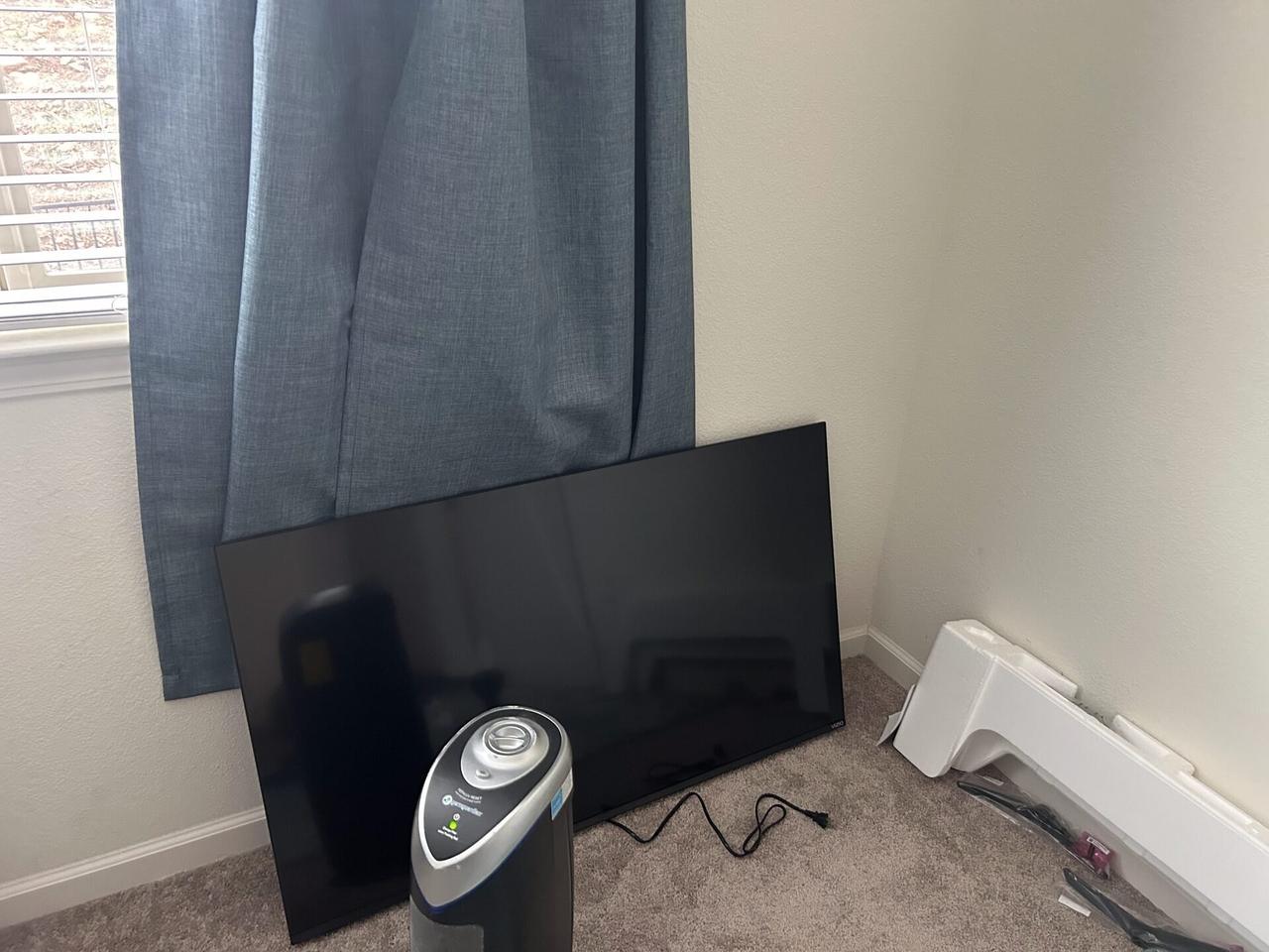 Smart technology service detail: wall-mounted TV setup and cable routing for home theater support