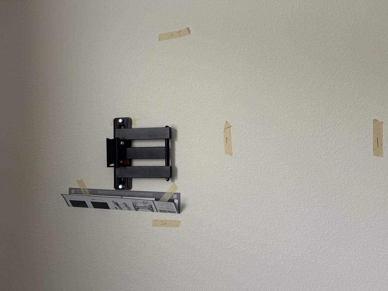 TV mounting or home theater setup detail with display placement, mount work, cabling or finished installation context