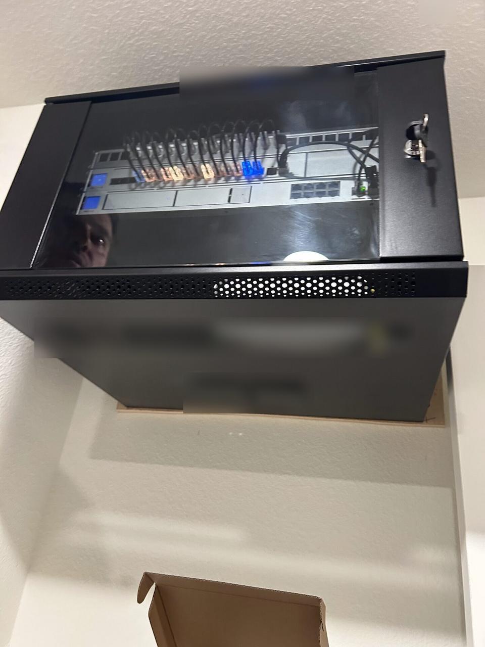 Onsite service photo showing Ubiquiti-style security network cabinet