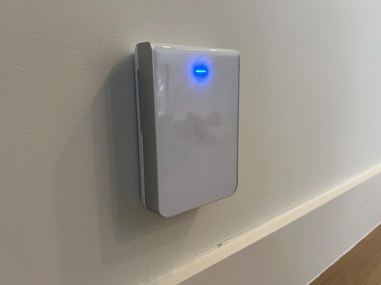 Public-safe portfolio image of wall-mounted home access point