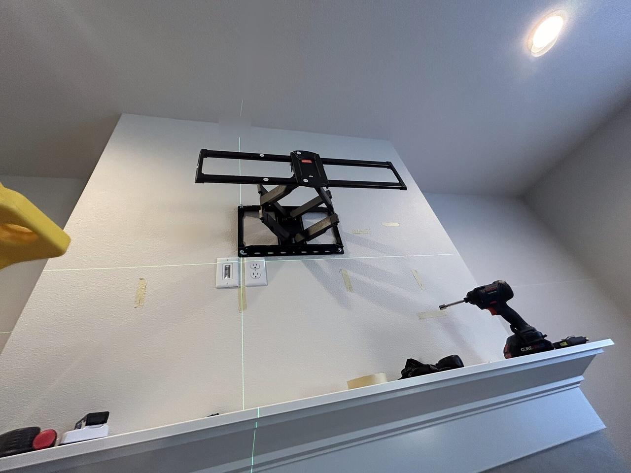 Onsite service photo showing wall-mounted TV setup and cable routing with cable routing visible
