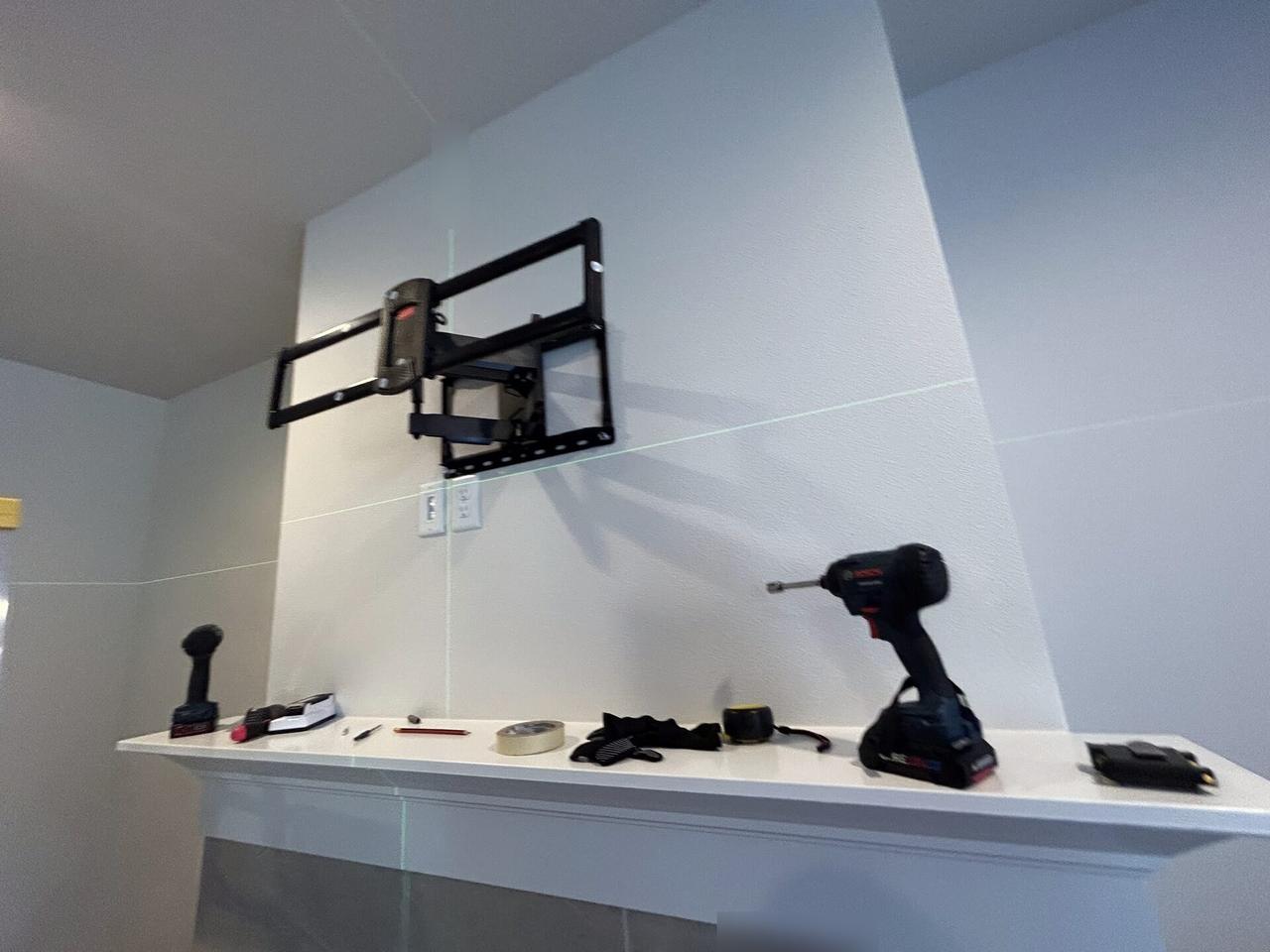 TV mounting and display setup work near the mounting location during an Alrty onsite service visit