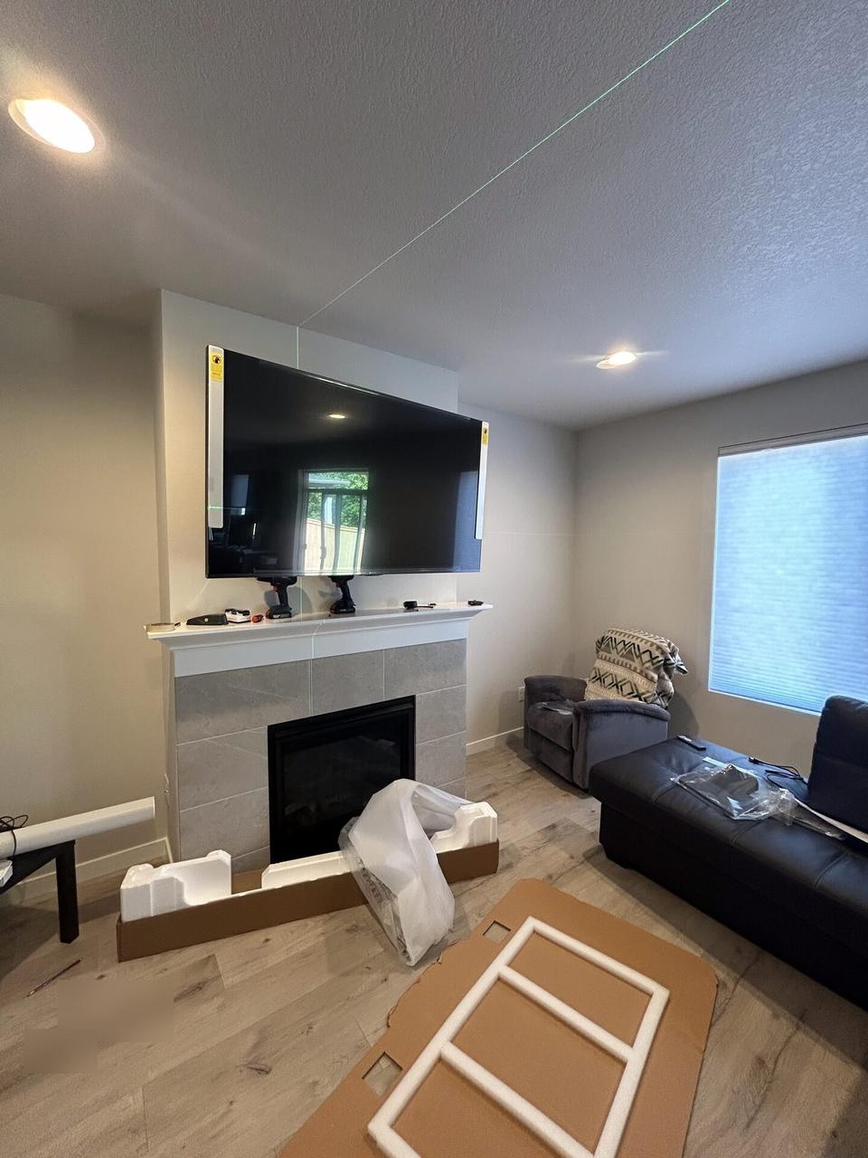 Service documentation showing TV mounting and display setup work before final viewing checks