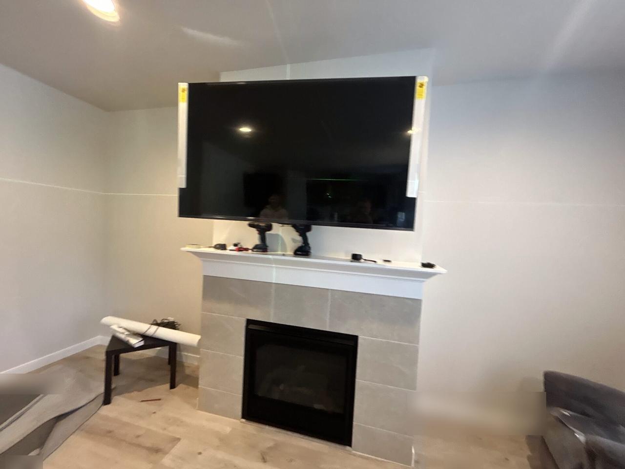Public-safe portfolio image of display bracket or mounting preparation onsite with wall hardware context