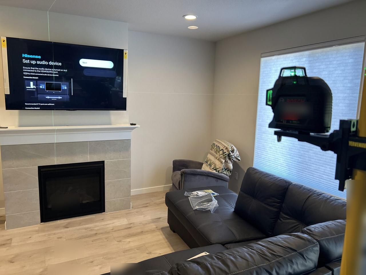 Alrty field photo with home theater cabling and display service detail with wall hardware context