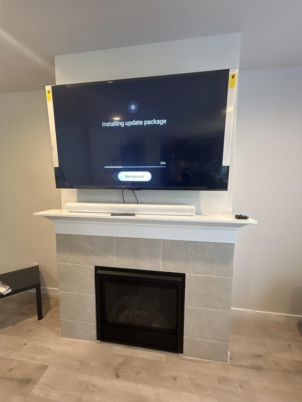 Smart technology service detail: wall-mounted TV setup and cable routing with private room details omitted