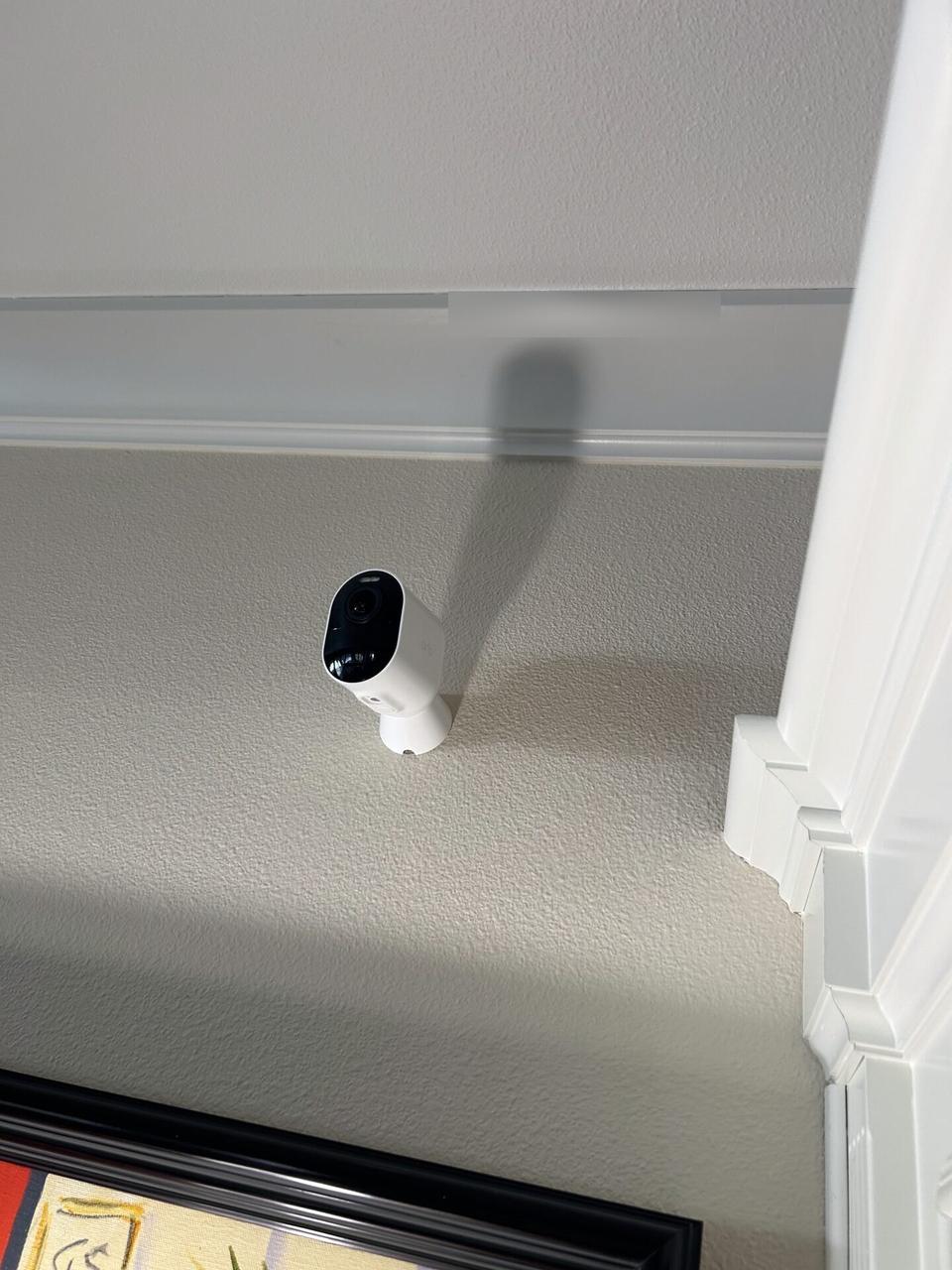 Onsite service photo showing smart security device wiring during onsite work with private views omitted