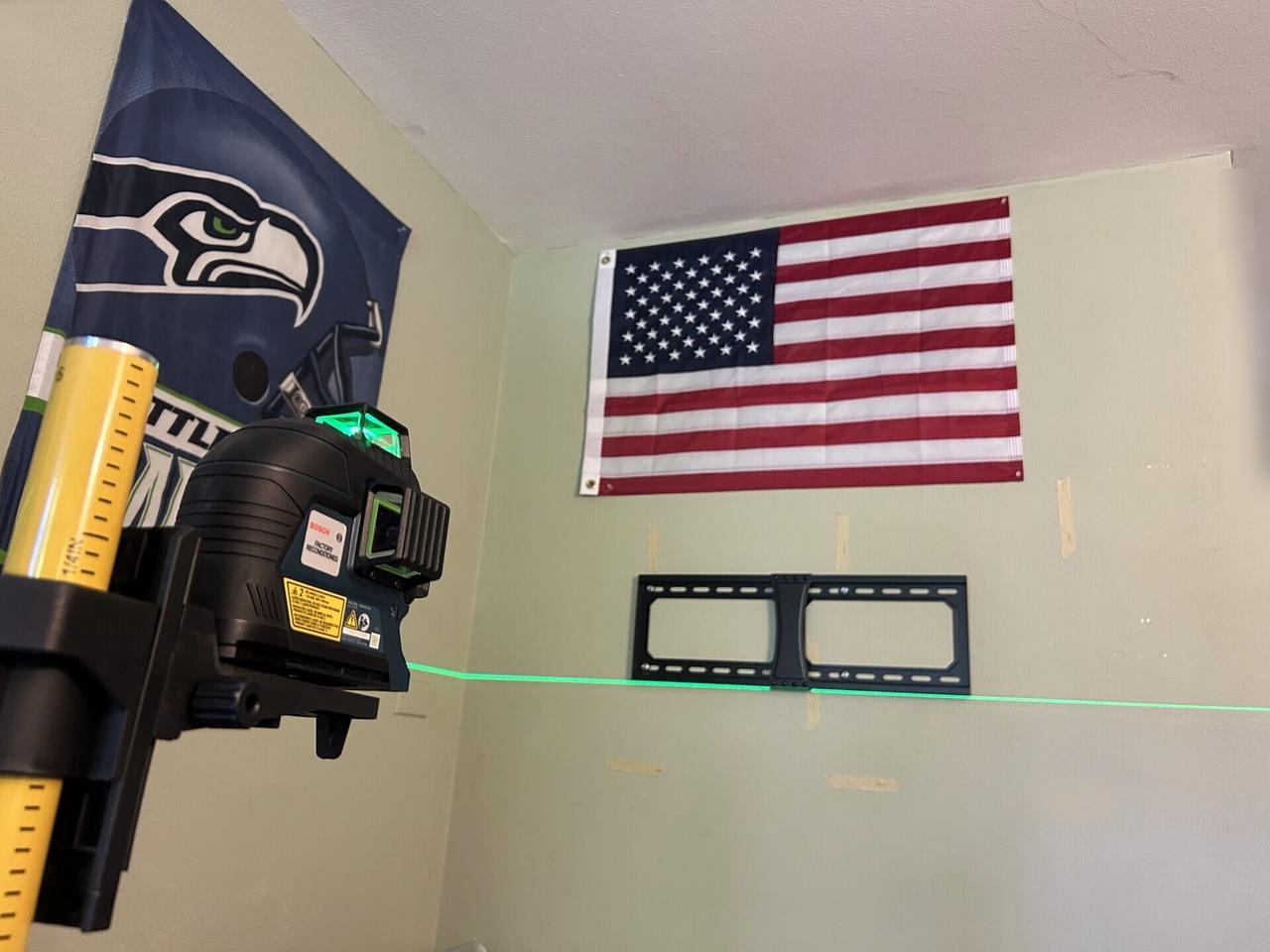 Onsite service photo showing wall-mounted TV setup and cable routing before final viewing checks