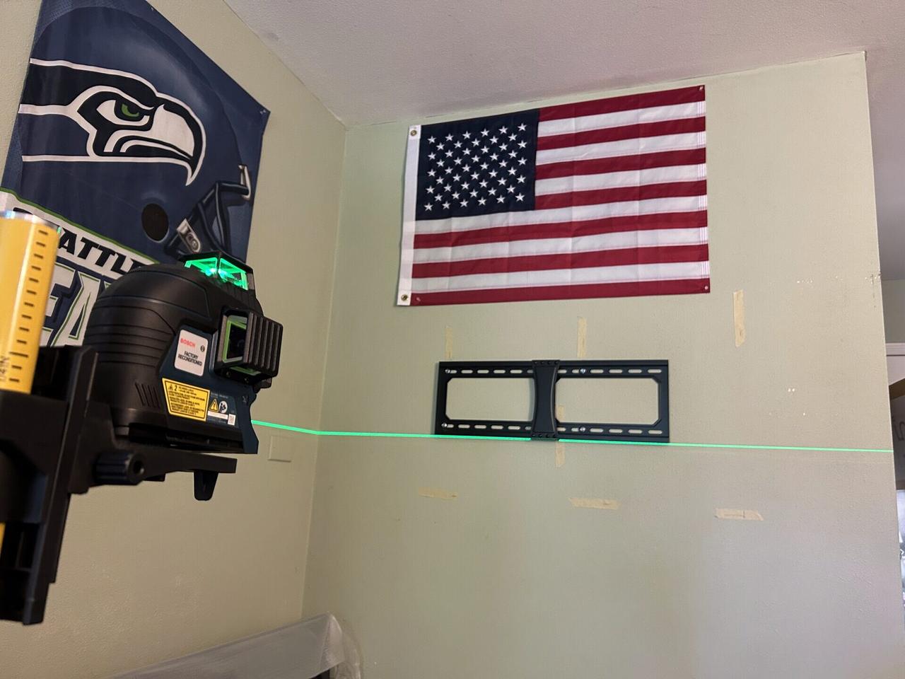 TV mounting layout with laser level marks before bracket placement