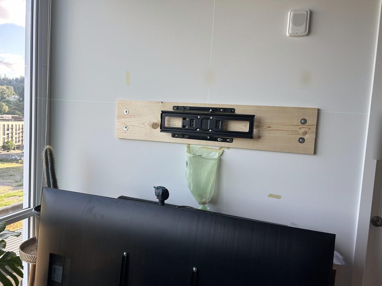 TV wall mount plate and cable path prepared before final screen placement